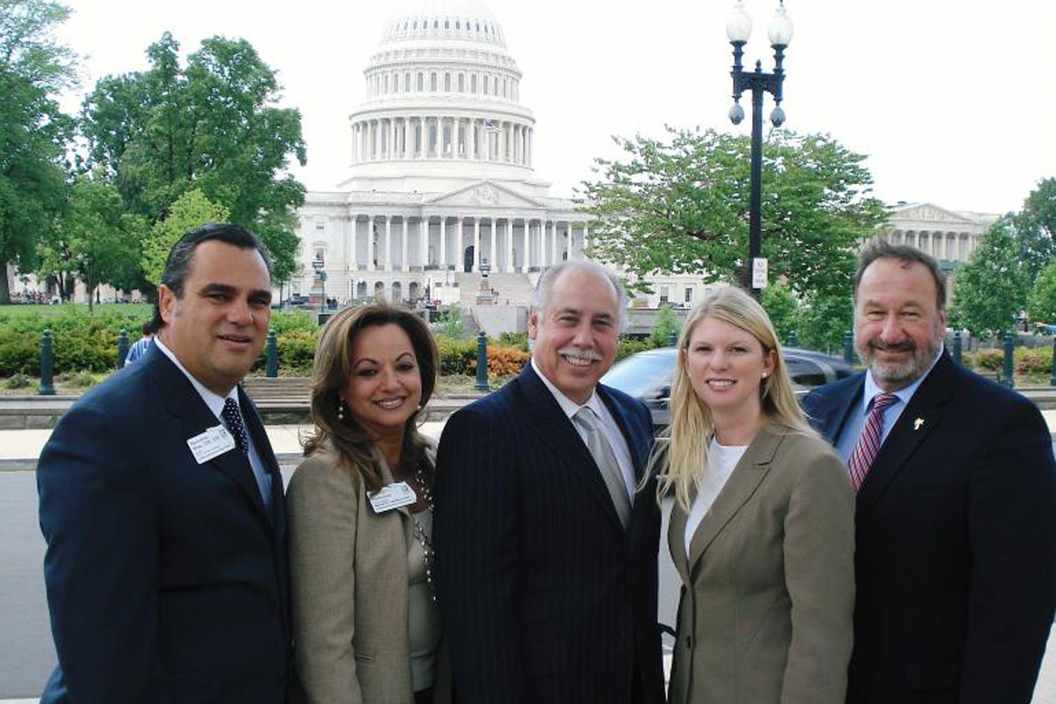 A group of people standing in front of the capitol building.