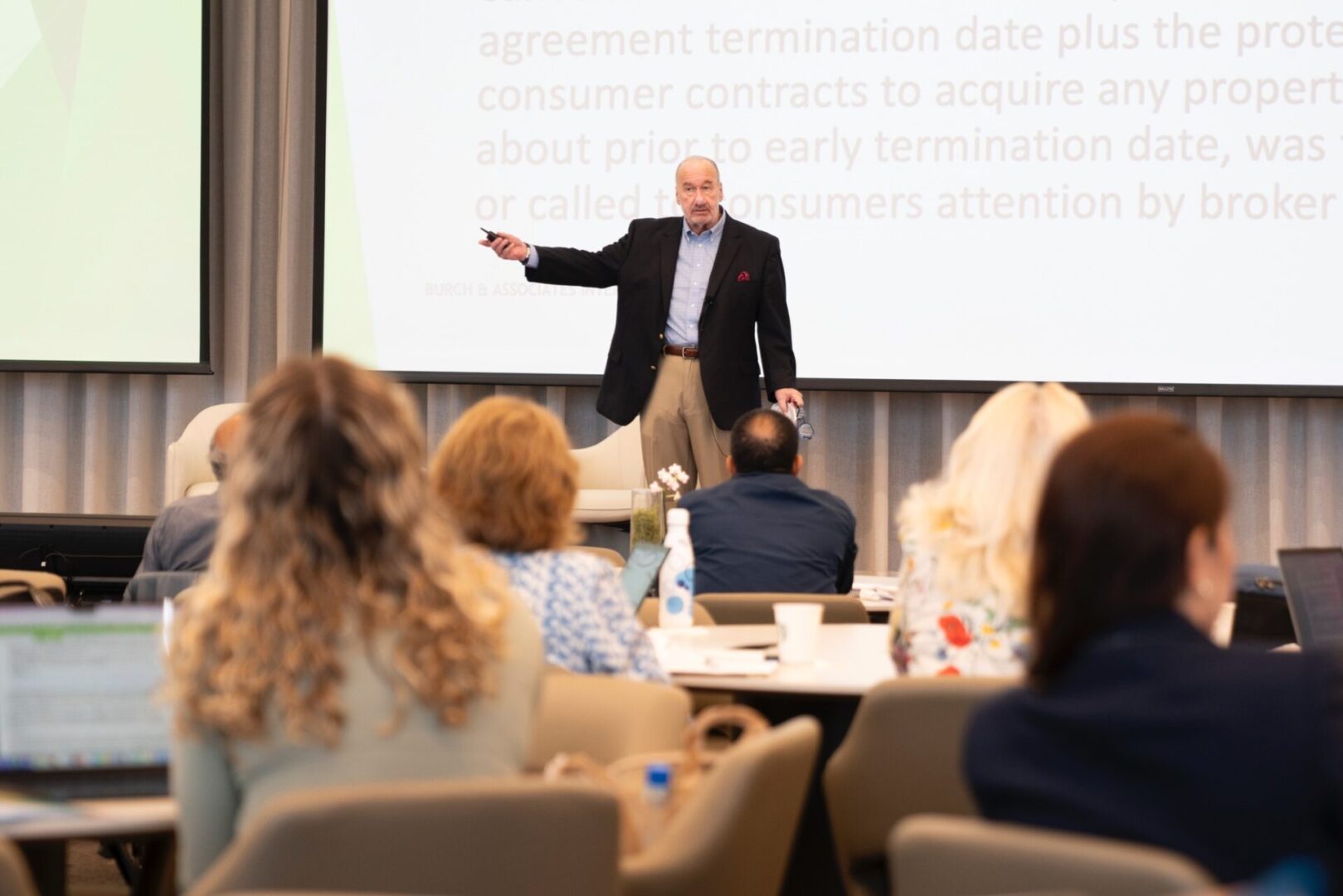 A man in a suit is giving a presentation